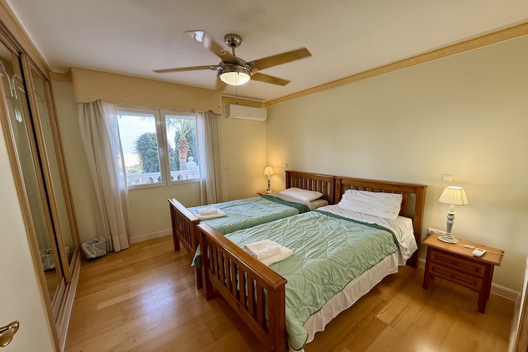 Twin beds with pool and sea views